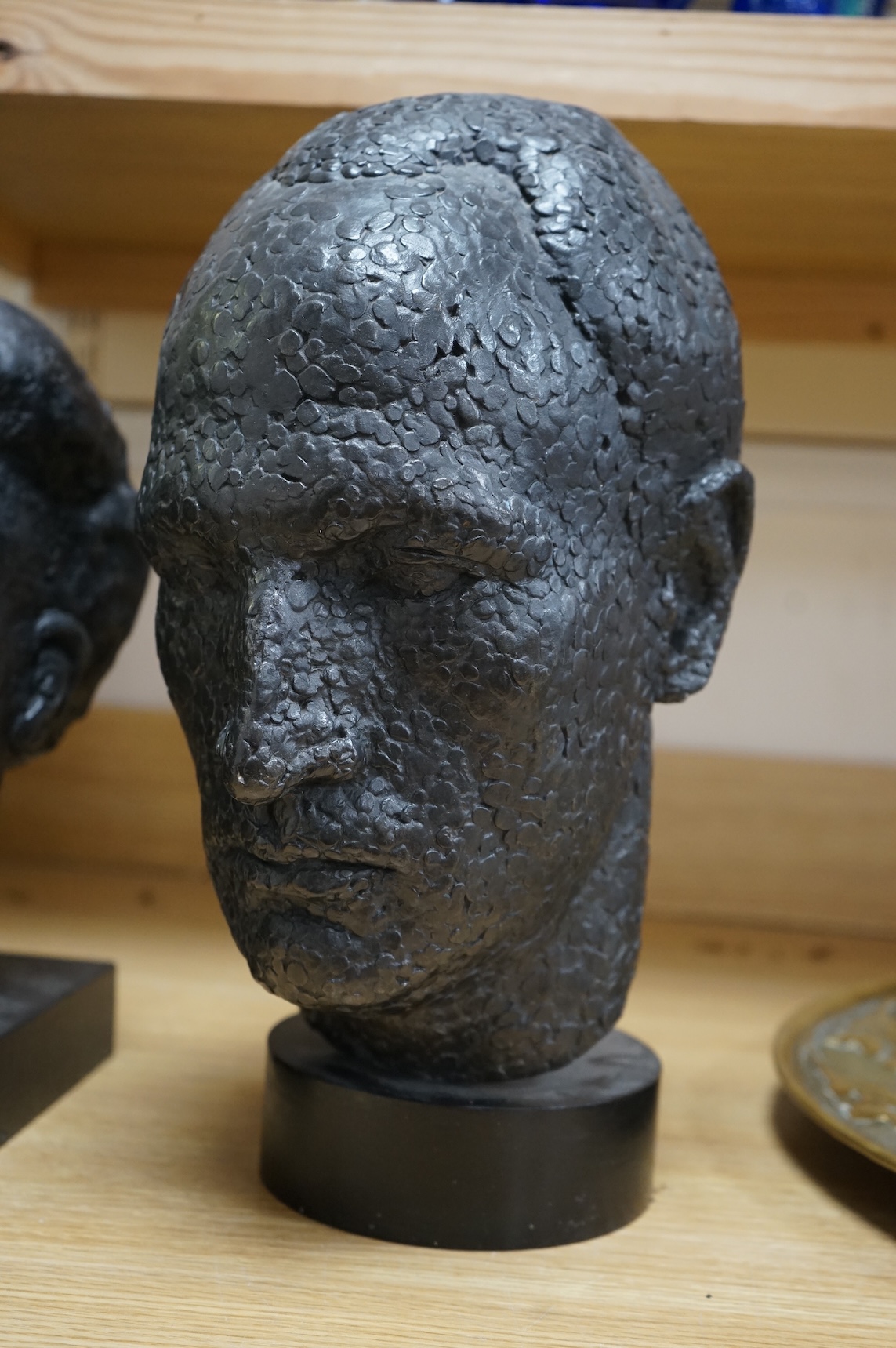 Six black painted composition heads, by Hazel Armour, tallest 49cm